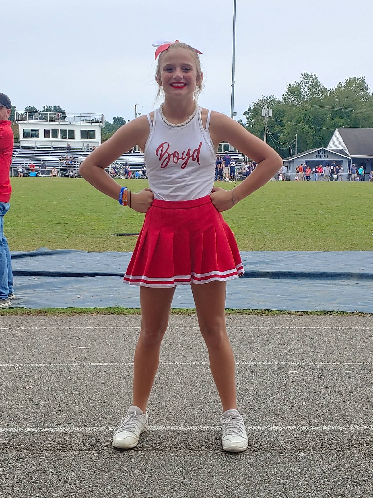 Makennah is registered to the contest to win money with this photo: asphalt, cheerleading, cheerleading_uniform, dance, electric_blue, event, fun, human_leg, joy, knee, person, recreation, road, sky, smile, sneakers, sports_uniform, sportswear, summer, tent