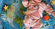 Nara joined the competition — help win amazing prizes! baby, infant, child, portrait, smiling, lying_down, play_mat, inflatable, ocean_theme, sea_animals, colorful, pink_clothing, onesie, socks, indoor, textured_background, toy, playtime, happy, photography