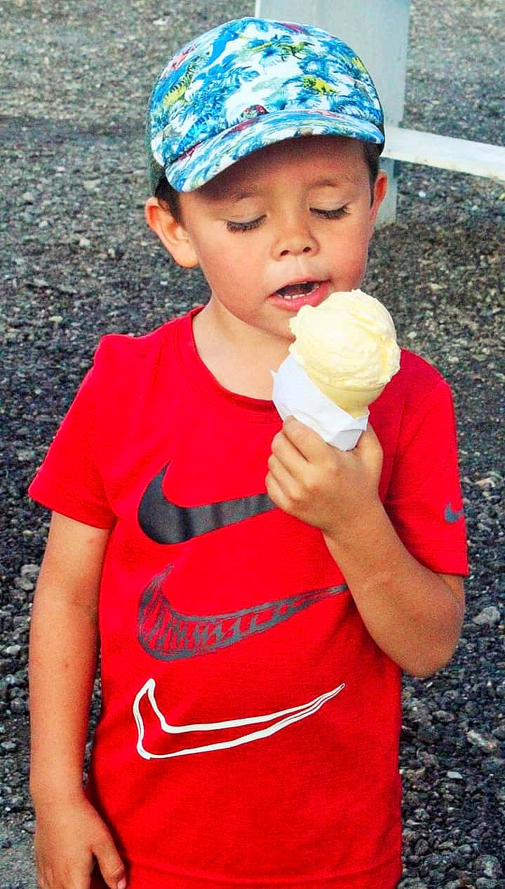 Deacon is registered to the contest to win money with this photo: baseball_cap, blue, cap, child, dairy, dessert, electric_blue, face, finger, food, frozen_dessert, fun, headwear, ice_cream, ice_cream_cone, person, pink, sleeve, soft_serve_ice_creams, summer