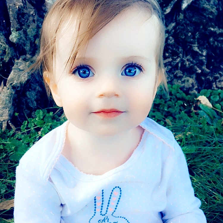 Sharlotte is registered to the contest to win money with this photo: baby, blond, blue, cheek, child, eye, face, grass, hair, head, iris, lip, people, photography, plant, portrait, skin, smile, toddler, tree