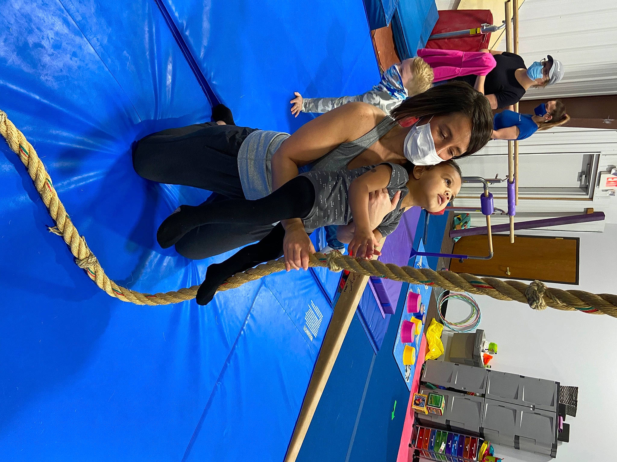 Amira is registered to the contest to win money with this photo: adventure, balance, blue, elbow, electric_blue, engineering, entertainment, event, fun, hat, headwear, leisure, machine, mast, performance, person, public_event, recreation, rope, smile