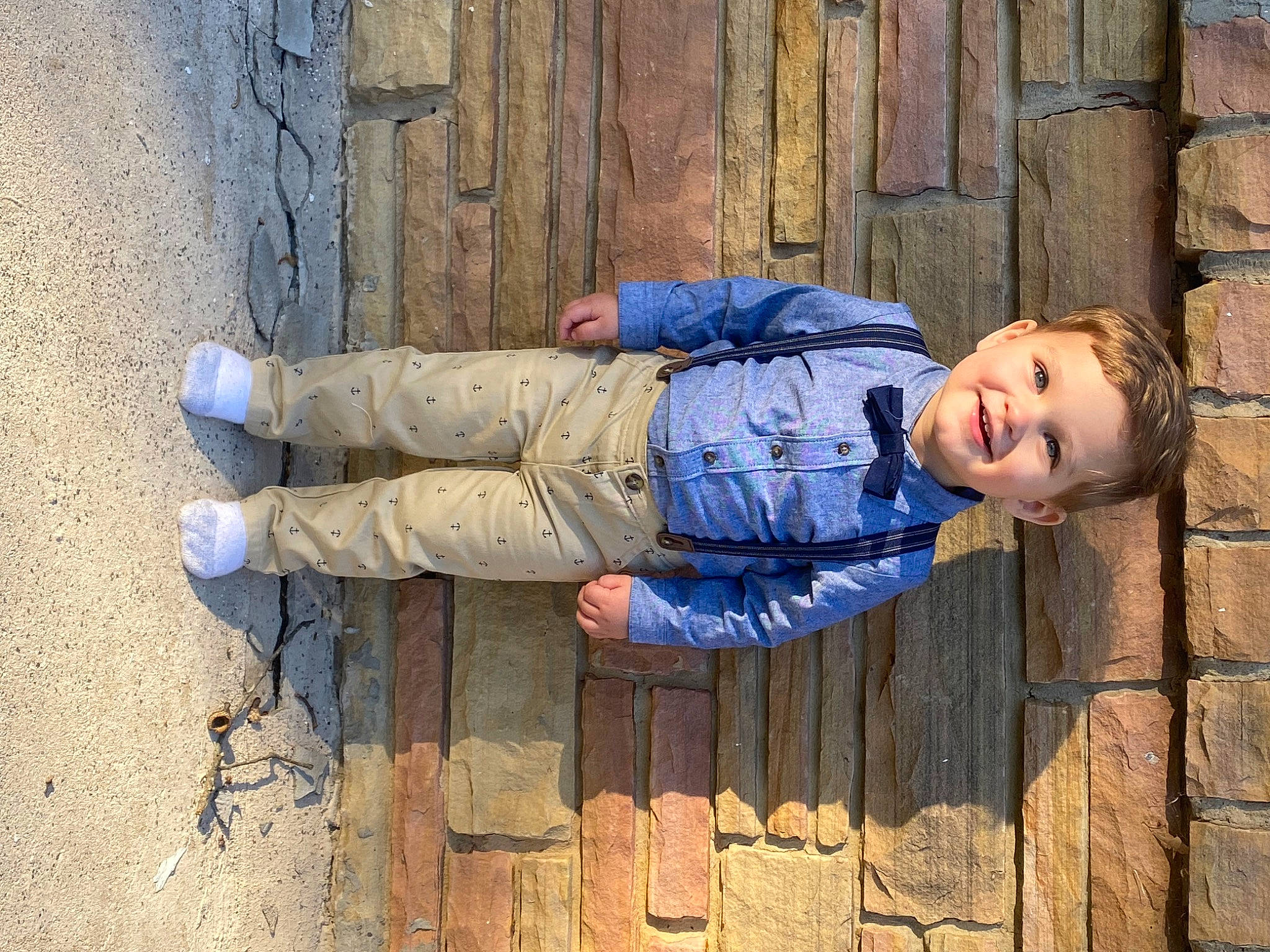 Bentley joined the competition — help win amazing prizes! azure, brick, brickwork, child, cobblestone, concrete, electric_blue, flooring, foot, gesture, happy, human_leg, joy, pattern, people_in_nature, person, shadow, sitting, smile, soil