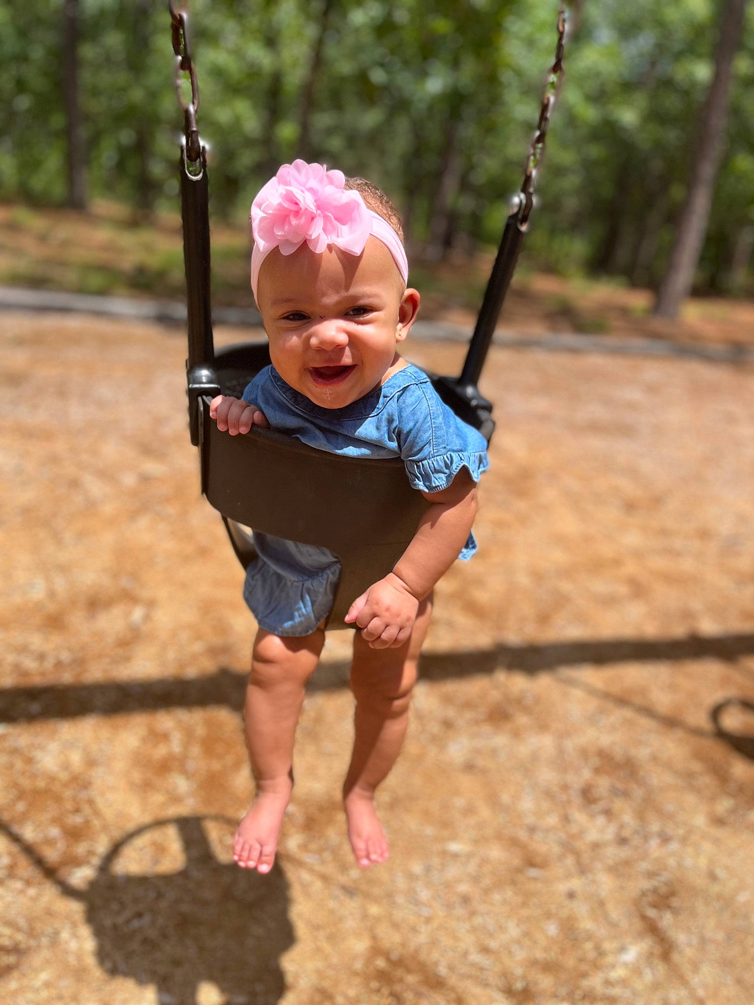 Anari is registered to the contest to win money with this photo: baby, baby_toddler_clothing, child, fun, grass, happy, leaf, leisure, outdoor_play_equipment, people_in_nature, person, pink, playground, public_space, recreation, sleeve, summer, swing, t_shirt, toddler