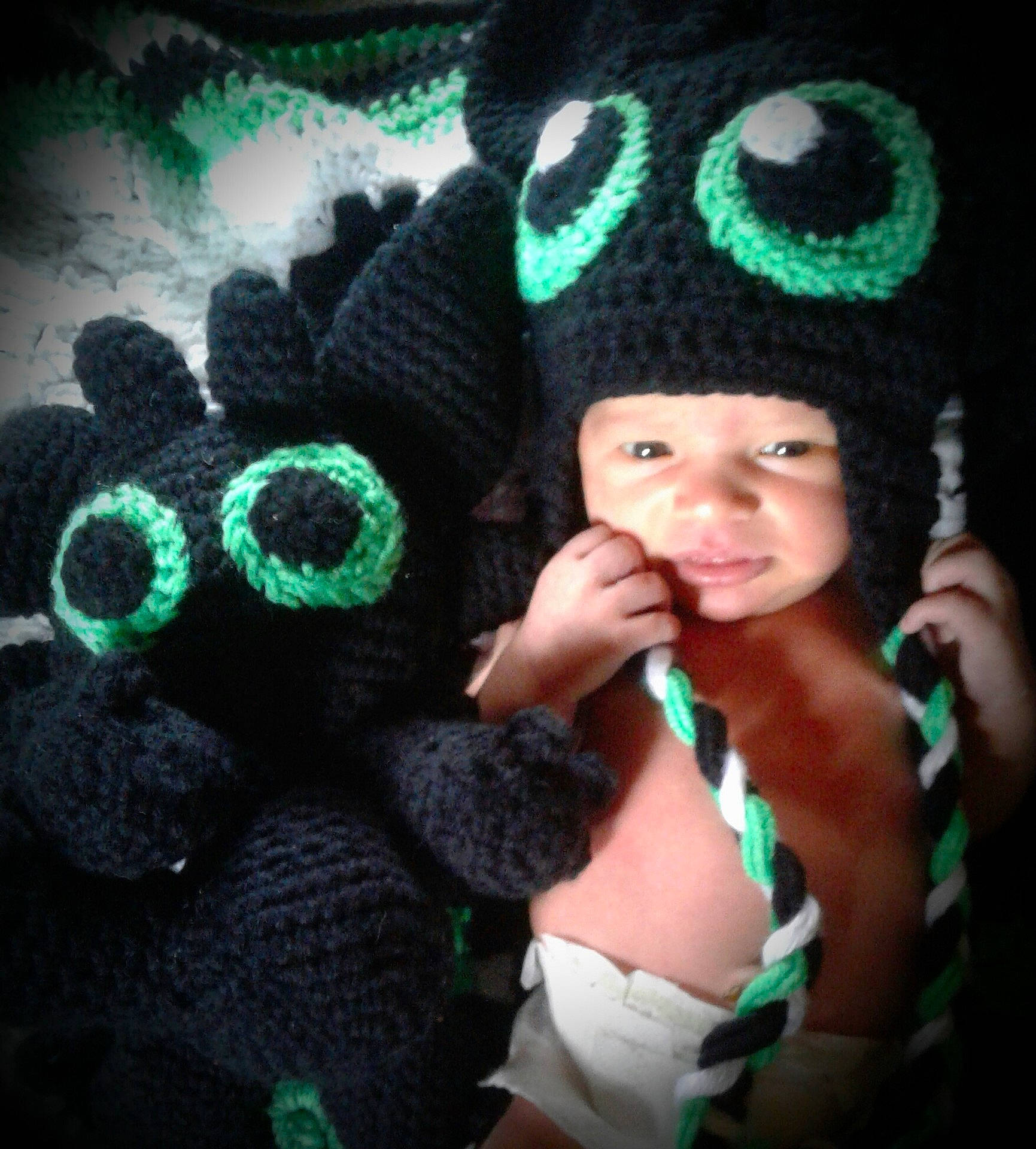 Tyler is registered to the contest to win money with this photo: beanie, black_hair, cap, crochet, girl, hat, headgear, knit_cap, knitting, person, product, smile, toddler, woolen