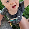 Benny is registered to the contest to win money with this photo: baby, child, infant, smiling, happy, outdoor, grass, lawn, portrait, close_up, face, blue_eyes, open_mouth, casual_clothing, t_shirt, wooden_bench, seated, daylight, playful, photography