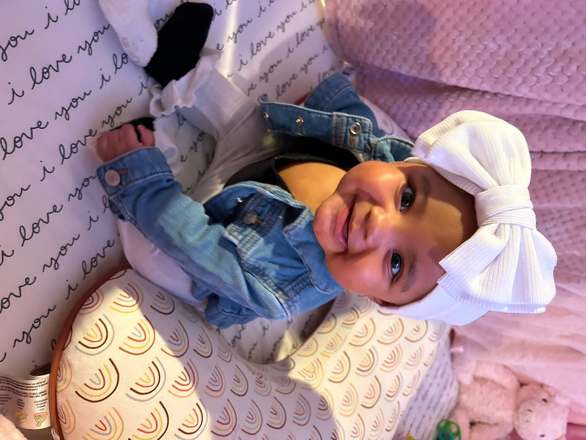 Nandi joined the competition — help win amazing prizes! bedding, child, comfort, couch, eyelash, happy, hat, headwear, joy, linens, magenta, mouth, pattern, person, pillow, pink, purple, room, sitting, smile