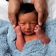 Riley is registered to the contest to win money with this photo: baby, newborn, infant, parent_hands, hands, blue_blanket, faux_fur, blanket, portrait, close_up, face, cheeks, fingers, cozy, soft_texture, skin, bed, comfort, sleepy, newborn_photography