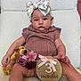 Rosaleigh joined the competition — help win amazing prizes! baby, infant, girl, headband, bow, pink_clothing, plush_toy, dog_toy, flowers, wooden_sign, milestone, sitting, white_chair, portrait, cute, child, face, hands, legs, indoor