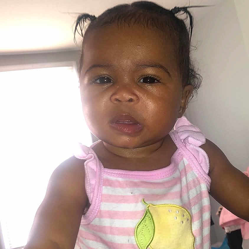 Jadiyah is registered to the contest to win money with this photo: toddler, child, baby, indoor, pink_clothing, striped, lemon_patch, curious, hands, portrait, young_child, person, cute, expression, hair_pigtails, window, natural_light, skin, face, casual