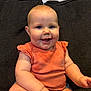 Emmalee joined the competition — help win amazing prizes! baby, child, smiling, orange_top, couch, indoor, happy, cute, chubby, sitting, drool, face, skin, person, infant, portrait, short_sleeves, plump, background, seated