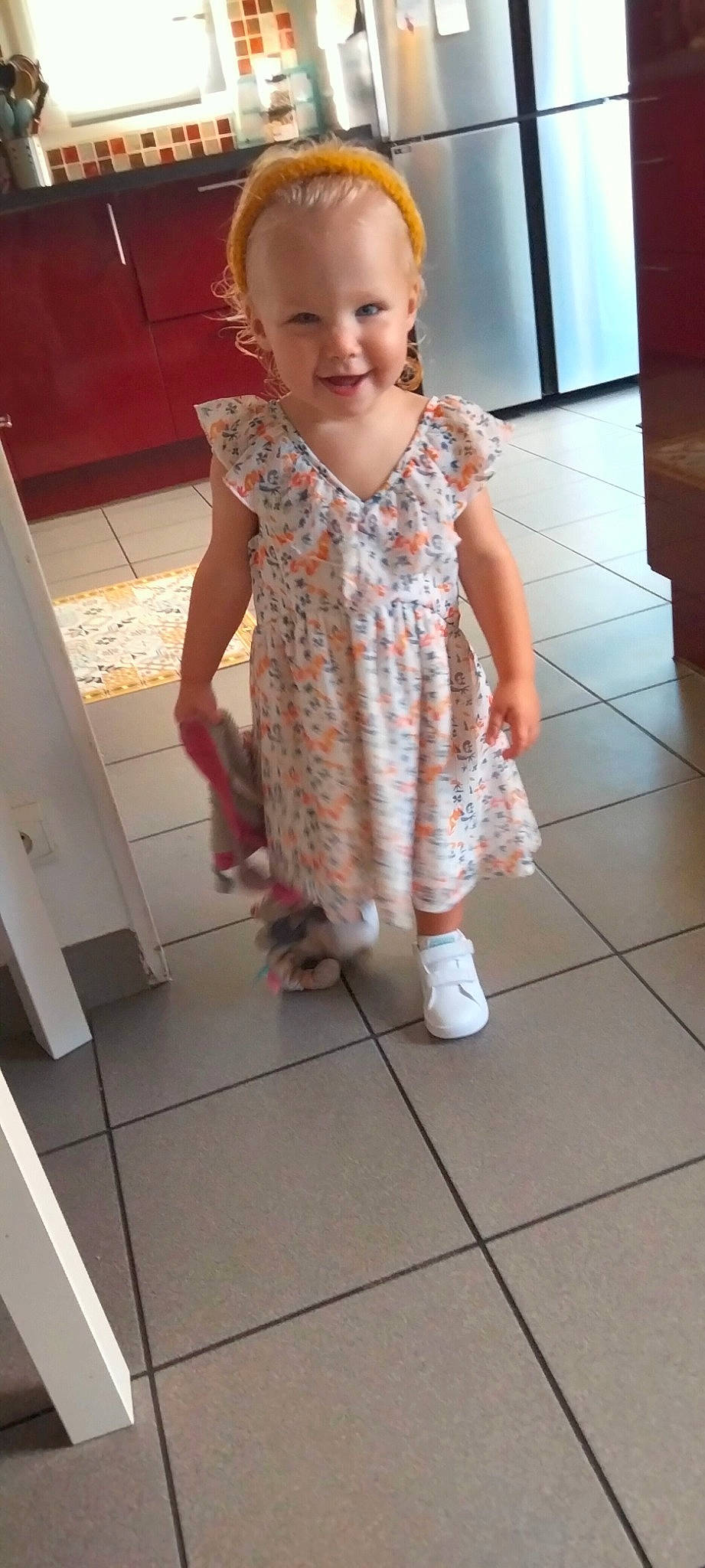 Vic participe au concours pour gagner de l'argent avec cette photo : baby_toddler_clothing, cheek, child, dress, eye, face, finger, floor, flooring, iris, joint, joy, neck, one_piece_garment, person, pink, skin, sleeve, smile, thumb