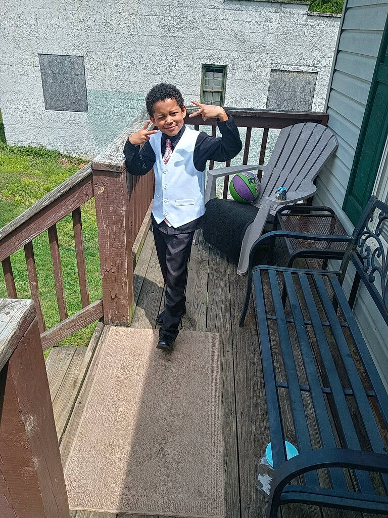 Keagan joined the competition — help win amazing prizes! backpack, bag, boot, deck, fun, grass, handrail, house, joy, leisure, luggage_and_bags, person, roof, shorts, smile, stairs, tourism, travel, vacation, walkway