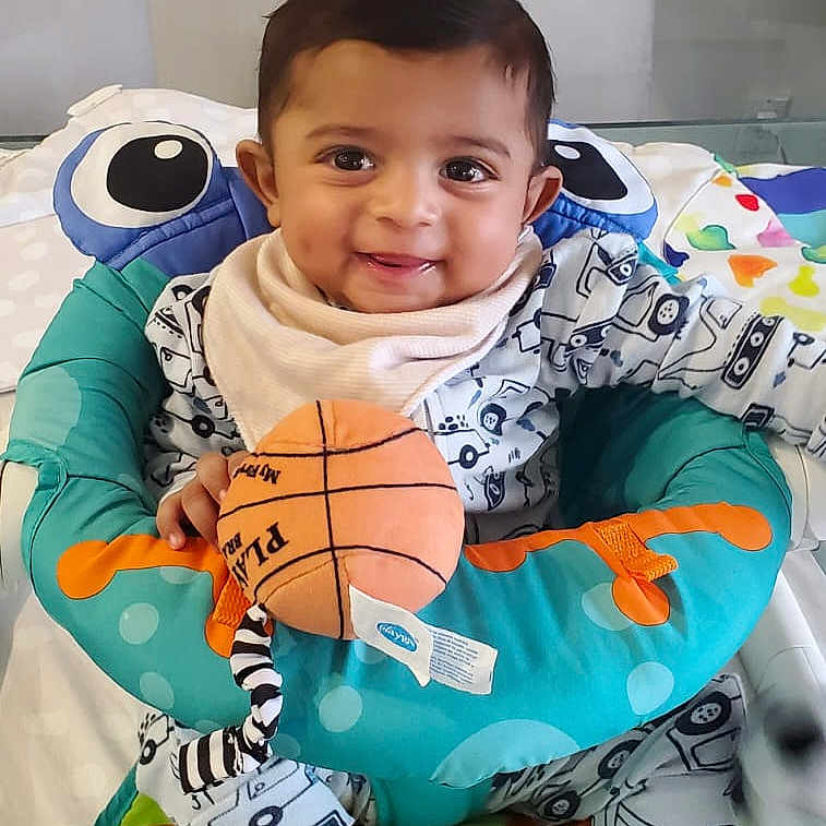 Dev joined the competition — help win amazing prizes! baby, ball, basketball, basketballball, blanket, cushion, face, football, furniture, happy, head, homedecor, indoors, person, photography, pillow, portrait, sitting, smile, sport