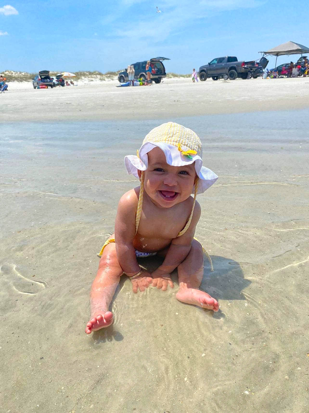 Alaia joined the competition — help win amazing prizes! beach, body_of_water, cloud, coast, fun, hat, headwear, holiday, joy, landscape, leisure, natural_environment, people_on_beach, person, personal_protective_equipment, sand, shore, sky, smile, summer