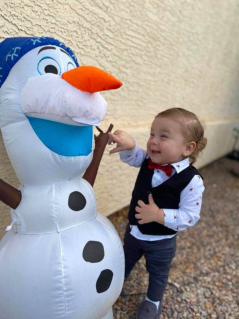 Asher is registered to the contest to win money with this photo: baby, baby_toddler_clothing, blue, clothing, fun, gesture, happy, hat, mammal, mascot, organ, outerwear, person, plant, recreation, sleeve, smile, toddler, tree, vertebrate