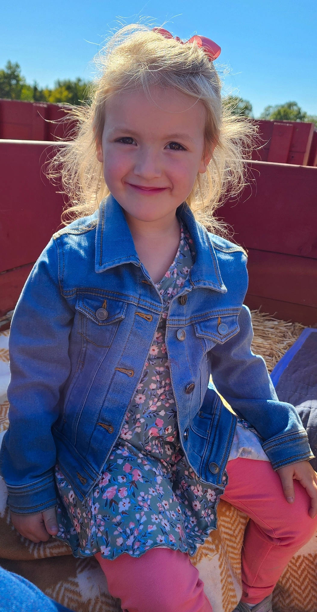 Emilia is registered to the contest to win money with this photo: blond, blue, brown_hair, child, denim, dress_shirt, electric_blue, facial_expression, fun, grass, hairstyle, happy, head, joy, leisure, pattern, person, sky, sleeve, smile