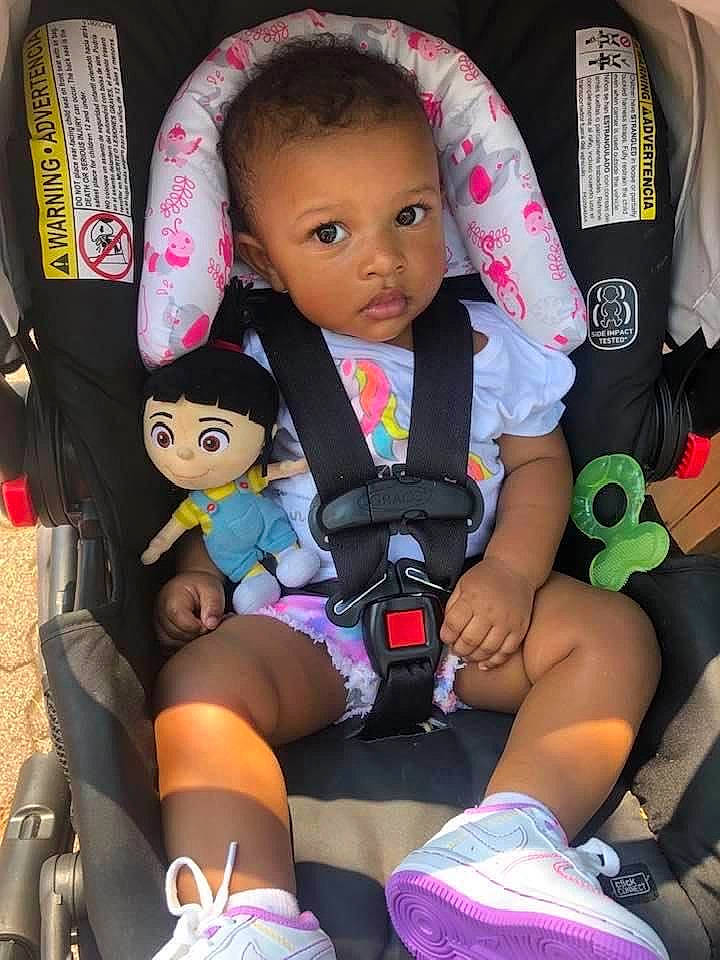 Jojo is registered to the contest to win money with this photo: baby, baby_carriage, baby_products, baby_toddler_clothing, black, car_seat, comfort, doll, fun, lap, leg, person, pink, product, seat_belt, shorts, skin, textile, thigh, toddler