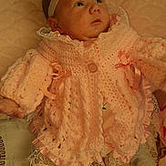 Ocean-Rae is registered to the contest to win money with this photo: adorable, baby, blanket, bow, child, cute, expression, fashion, headband, human, indoor, infant, knitted_clothing, lying_down, pink, portrait, socks, soft_texture, warm, young