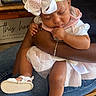 Keauni joined the competition — help win amazing prizes! baby, child, sleeping, headband, bow, white_sandals, denim, jeans, arm, hand, wooden_chair, indoor, home_decor, sign, table, peaceful, cute, dress, person, toddler