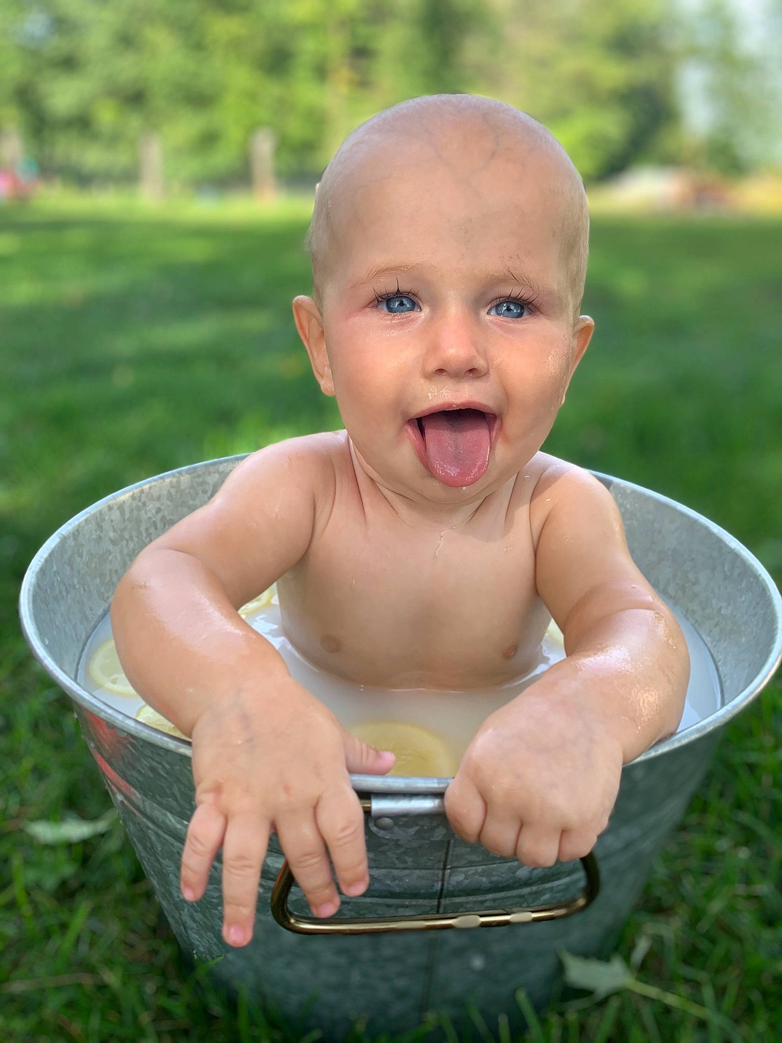 Atrues is registered to the contest to win money with this photo: baby, barechested, chest, child, facial_expression, finger, fun, grass, lawn, mouth, person, sitting, smile, summer, toddler, water