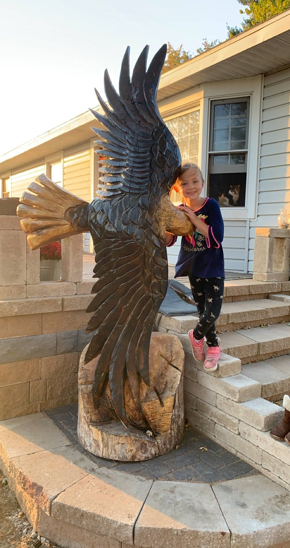 Ezmae is registered to the contest to win money with this photo: accipitriformes, art, beak, bird, bird_of_prey, carving, chainsaw_carving, eagle, falcon, falconiformes, hawk, joy, nonbuilding_structure, person, sculpture, statue, wing