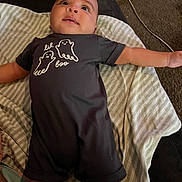 Princeston joined the competition — help win amazing prizes! baby, infant, child, lying_down, smiling, face, portrait, indoor, blanket, striped_blanket, onesie, clothing, ghost_design, arms_outstretched, carpet, cable, home, happy, looking_up, photograph
