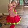 Allie Jo joined the competition — help win amazing prizes! child, costume, dance_pose, dress, girl, hair_bow, home, indoor, playful, portrait, red_clothing, skirt, smiling, standing, striped_shirt, toddler, tutu, vacuum_cleaner, watermelon, wooden_floor
