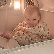 Allie Jo joined the competition — help win amazing prizes! baby, bath_time, bathroom, bathtub, child, cute, eyes, face, floral_clothing, hair, household, indoor, infant, light, onesie, photograph, playful, portrait, seated, smiling