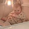 baby, bath_time, bathroom, bathtub, child, cute, eyes, face, floral_clothing, hair, household, indoor, infant, light, onesie, photograph, playful, portrait, seated, smiling