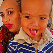 Jazzhy participe au concours pour gagner de l'argent avec cette photo : toddler, child, woman, face, tongue_out, close_up, portrait, smile, braids, red_lipstick, indoor, patterned_shirt, fun, playful, person, clothing, happy, expression, skin, head