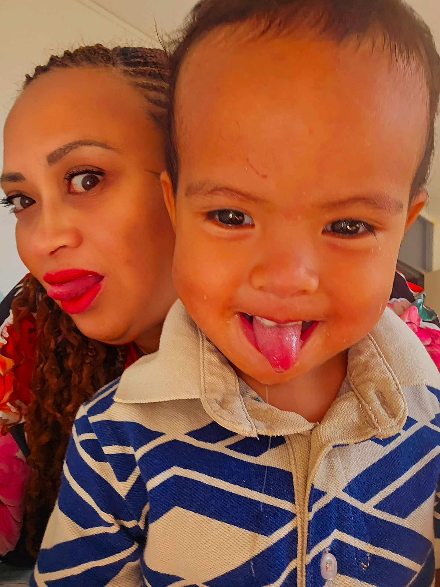Jazzhy participe au concours pour gagner de l'argent avec cette photo : toddler, child, woman, face, tongue_out, close_up, portrait, smile, braids, red_lipstick, indoor, patterned_shirt, fun, playful, person, clothing, happy, expression, skin, head