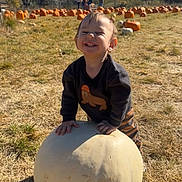 August joined the competition — help win amazing prizes! child, toddler, pumpkin, pumpkin_patch, white_pumpkin, smiling, happy, outdoor, grass, autumn, trees, blue_sky, sunny, nature, fall, person, clothing, pants, long_sleeve, daytime