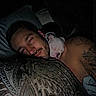 Frankie joined the competition — help win amazing prizes! man, dog, puppy, sleeping, cuddling, bed, bedroom, blanket, pillow, portrait, indoors, night, dim_lighting, pet, companion, white_dog, tattoo, beard, relaxed, snuggling