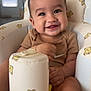 Julian joined the competition — help win amazing prizes! baby, smile, child, high_chair, bear_pattern, indoor, furniture, happy, person, infant, cute, clothing, seat, toy, home, face, hands, legs, light, background