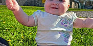 Abigail is registered to the contest to win money with this photo: baby, blue_sky, cheerful, child, cute, daylight, flower, grass, greenery, happy, nature, outdoor, park, person, playing, skirt, smiling, stick, sunny, tshirt