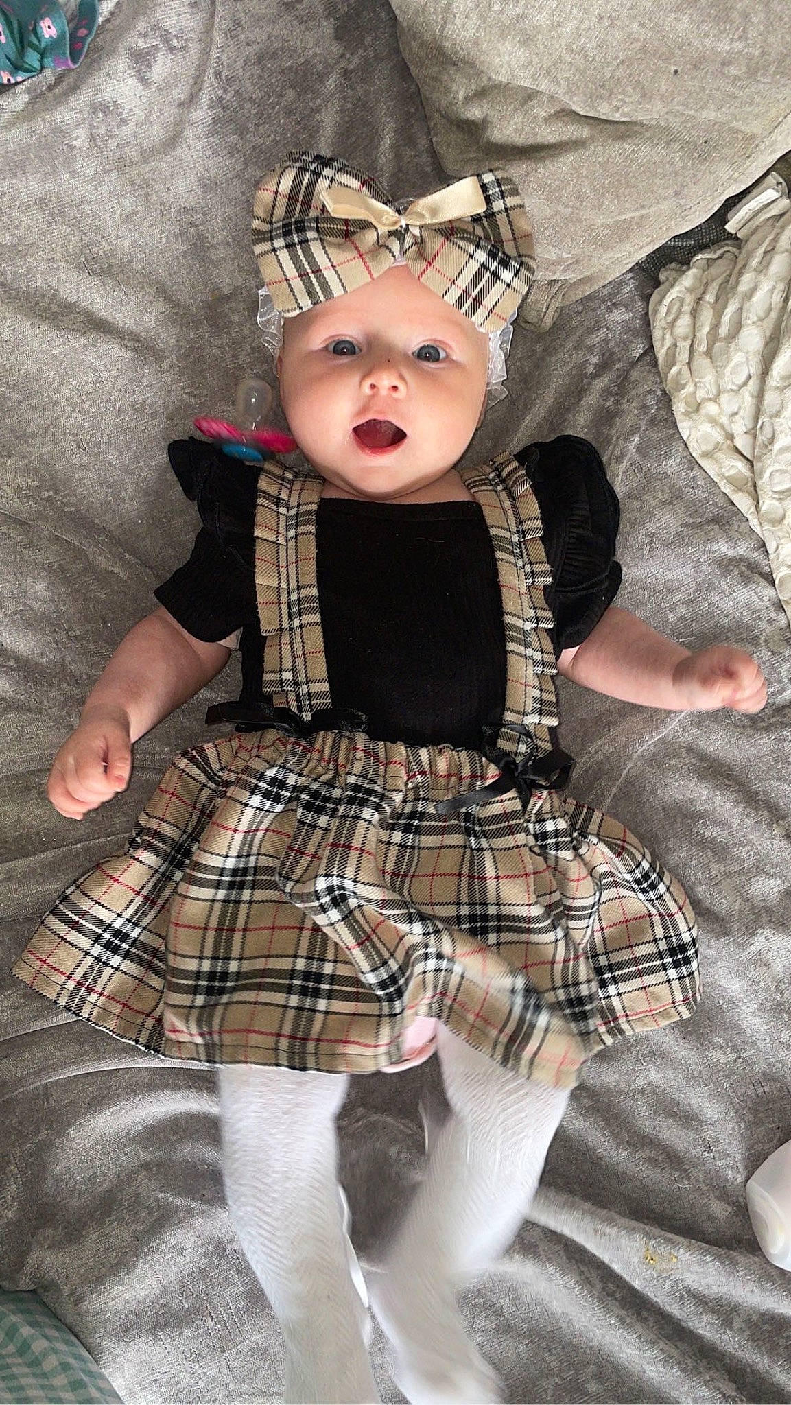 Kenzie is registered to the contest to win money with this photo: baby_toddler_clothing, child, costume_hat, day_dress, design, doll, dress, fashion_accessory, fashion_design, fawn, hair_accessory, headgear, headwear, one_piece_garment, pattern, person, plaid, sleeve, tartan, textile