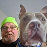 Butch joined the competition — help win amazing prizes! adult, animal, beanie, beard, brown_dog, casual_clothing, close_up, collar, companion, dog, face, friendly, glasses, home, indoor, indoor_lighting, looking_at_camera, man, pet, portrait
