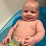 Isaiah is registered to the contest to win money with this photo: baby, bath, bathroom, bathtub, blue, cheeks, child, cute, hand, infant, naked, playful, relaxing, sitting, skin, smile, striped, towel, toy, water