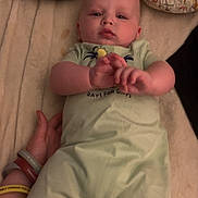 Isaiah joined the competition — help win amazing prizes! animal_print, baby, bedroom, blanket, bracelets, child, closeup, comfort, cute, expression, hand, indoor, infant, lying_down, person, pillow, portrait, romper, sleepwear, soft_lighting