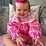 baby, child, pink, bow, smile, couch, cushion, clothing, footwear, indoor, person, cute, happy, toddler, hair, sitting, hand, face, playful, home