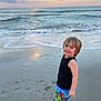 Zyah joined the competition — help win amazing prizes! child, beach, ocean, waves, sand, sunset, smile, barefoot, tank_top, shorts, superhero, water, sky, clouds, happy, outdoor, nature, footprints, playful, young