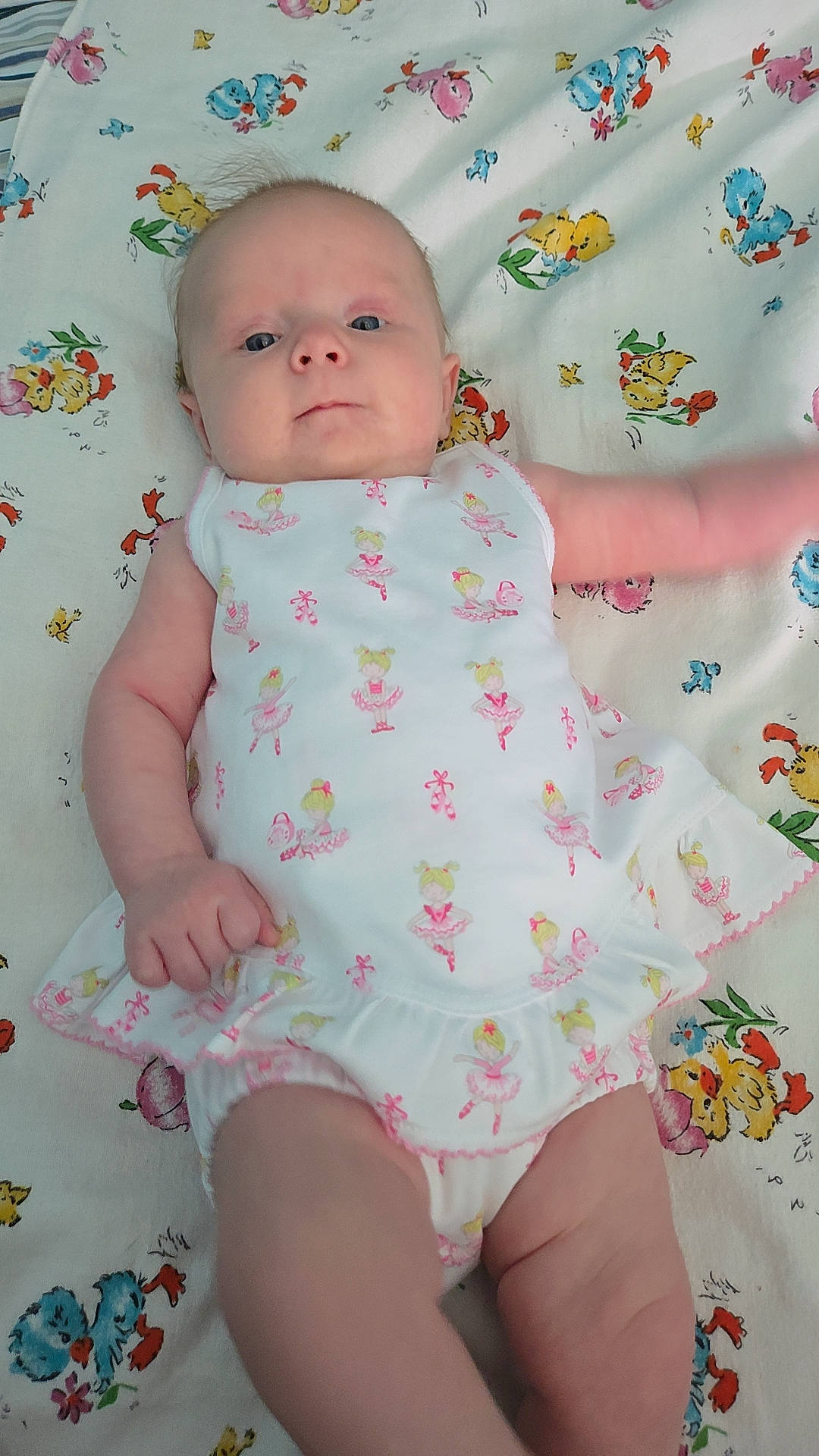baby, ballerina, blanket, blue_eyes, child, colorful, cute, dress, expression, face, fingers, foot, hand, infant, lying_down, pattern, pink, skin, soft, white