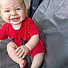 baby, child, smiling, red_clothing, blue_eyes, sitting, seat, cushion, indoor, happy, cute, infant, portrait, skin, hand, foot, person, one_person, casual, young_child