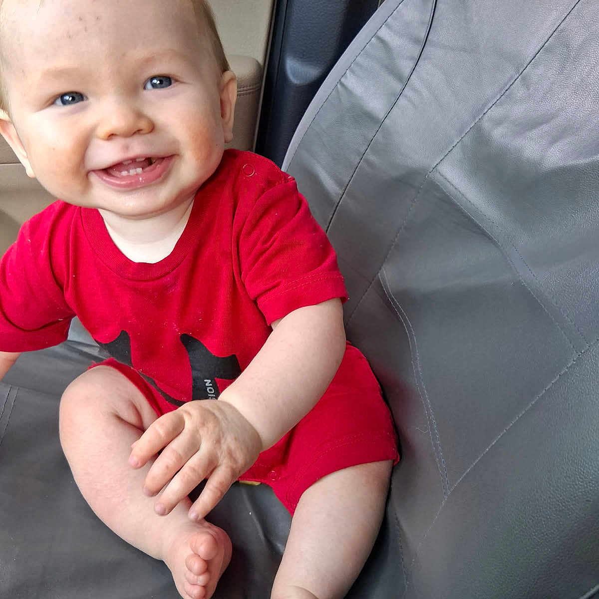 Leeham joined the competition — help win amazing prizes! baby, child, smiling, red_clothing, blue_eyes, sitting, seat, cushion, indoor, happy, cute, infant, portrait, skin, hand, foot, person, one_person, casual, young_child