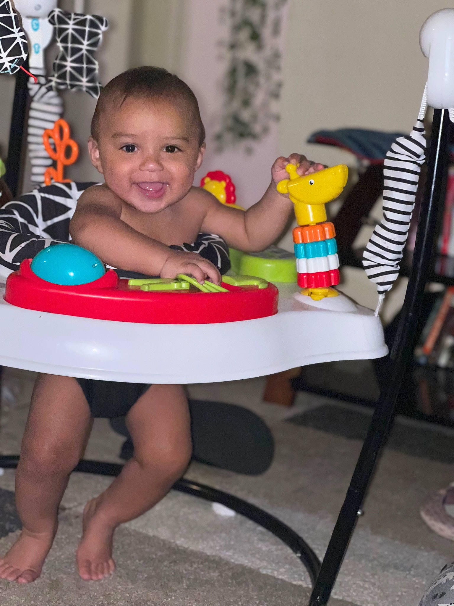 Kane is registered to the contest to win money with this photo: baby, baby_products, baby_toddler_clothing, chair, child, foot, fun, happy, human_leg, joy, leisure, person, play, room, sitting, skin, smile, standing, t_shirt, thigh