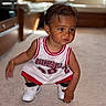 Konrad a rejoint le concours — aidez-le/la à gagner de superbes lots ! toddler, child, basketball, sportswear, sneakers, carpet, indoor, curious, squatting, young_child, white_shoes, red_trim, short_hair, person, portrait, flooring, candid, casual, expression, apparel