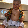 Konrad a rejoint le concours — aidez-le/la à gagner de superbes lots ! toddler, child, smile, shirt, pants, bare_chest, necklace, indoor, sitting, barefoot, cute, happy, portrait, young_child, fashion, accessory, skin, feet, baby, casual