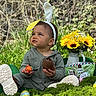 toddler, child, bunny_ears, headband, chocolate, egg, flowers, sunflowers, outdoor, grass, greenery, toy, playful, face, clothing, boots, nature, portrait, sitting, daylight