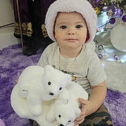 Eyden joined the competition — help win amazing prizes! baby, child, santa_hat, stuffed_animal, polar_bear_toy, purple_rug, camouflage_pants, christmas_tree, holiday_decor, ornaments, purple_ornaments, white_ornaments, toy, festive, indoors, portrait, smiling, decorative_figure, staff, plush_toy