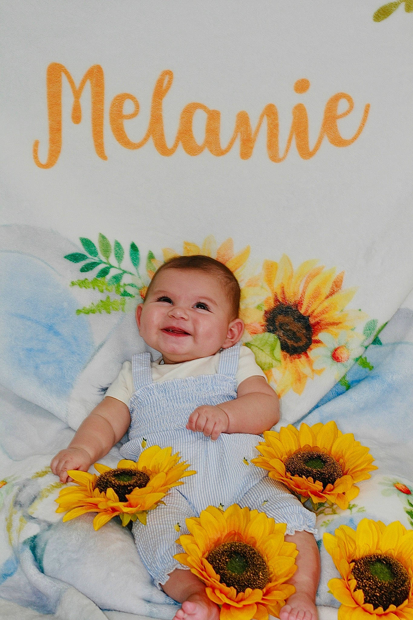 Melanie is registered to the contest to win money with this photo: art, baby, baby_toddler_clothing, child, cut_flowers, facial_expression, flower, flower_arranging, font, happy, joy, morning, orange, pattern, people_in_nature, person, petal, plant, product, smile